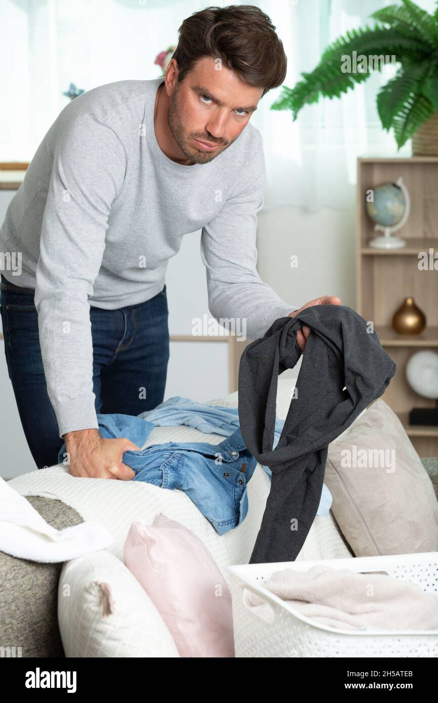 young bored and tired man posing with laundry Stock Photo - Alamy