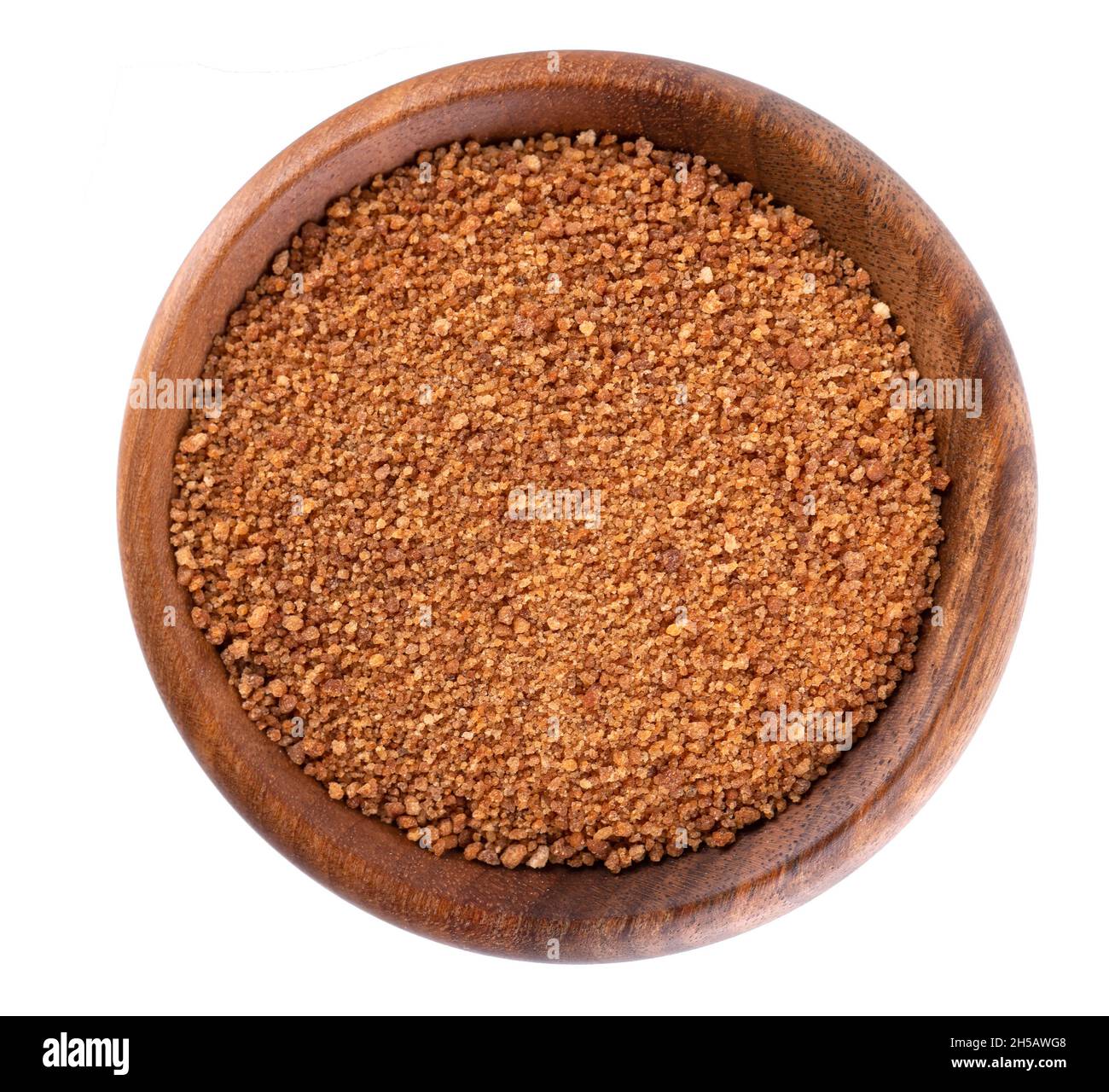 Coconut sugar isolated on white background. Brown unrefined coconut palm sugar in wooden bowl. Top view. Stock Photo
