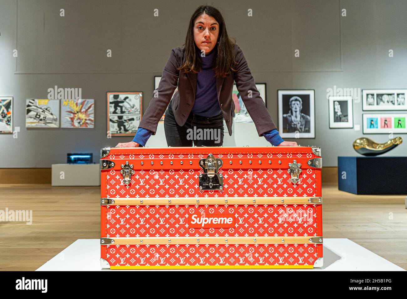 NEW BOND STREET LONDON, UK. 8 Nov, 2021. LOUIS VUITTON X SUPREME, A Limited  Edition Red And White Monogram Malle Courrier 90 Trunk, 2019, Estimate: £  60,000 - 80,000 at the Bonhams