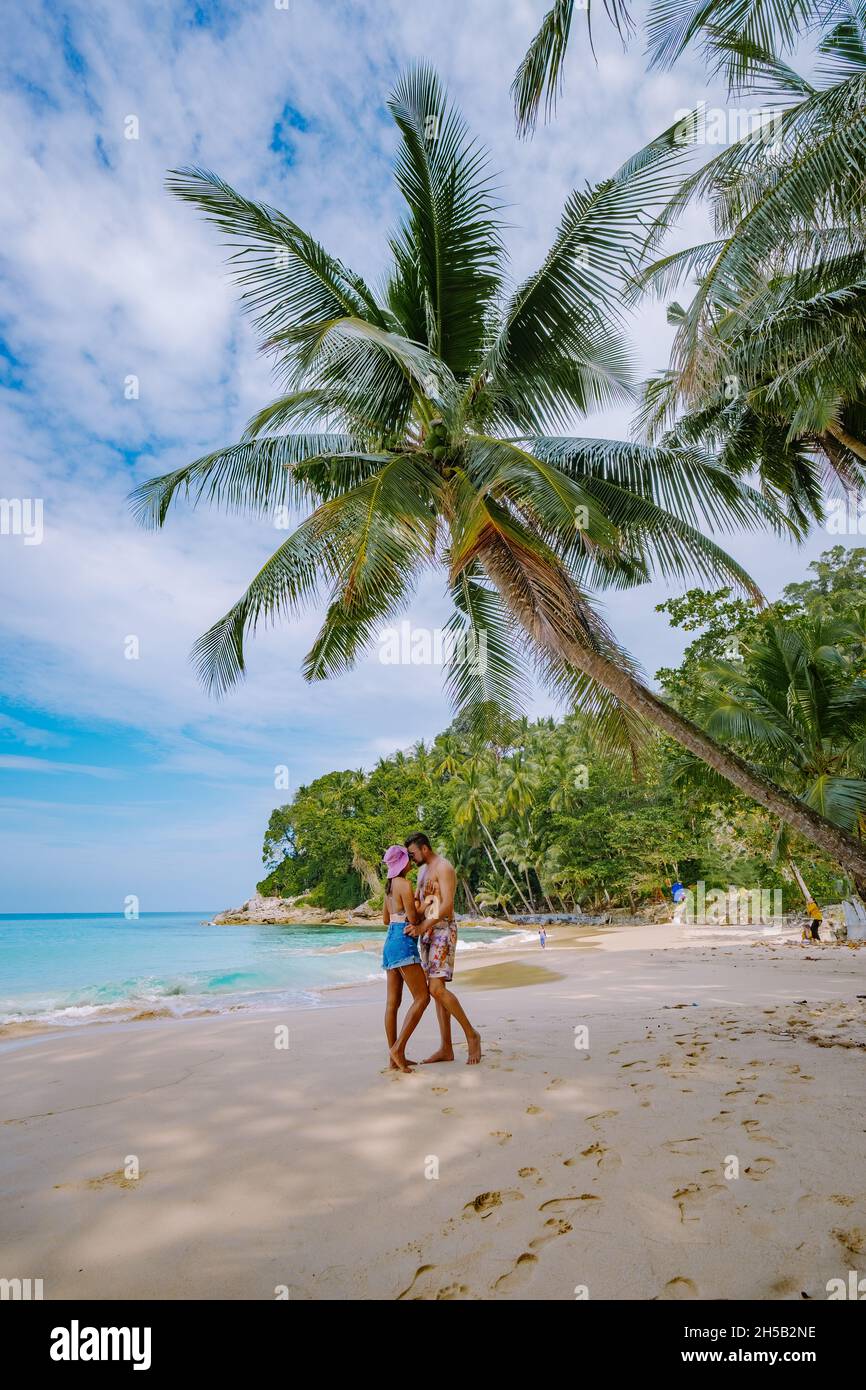 Surin beach in Phuket, southern of Thailand, famous tourist destination in  Phuket, Beautiful beach, View of nice tropical beach with palms around.  couple man and woman on beach Stock Photo - Alamy