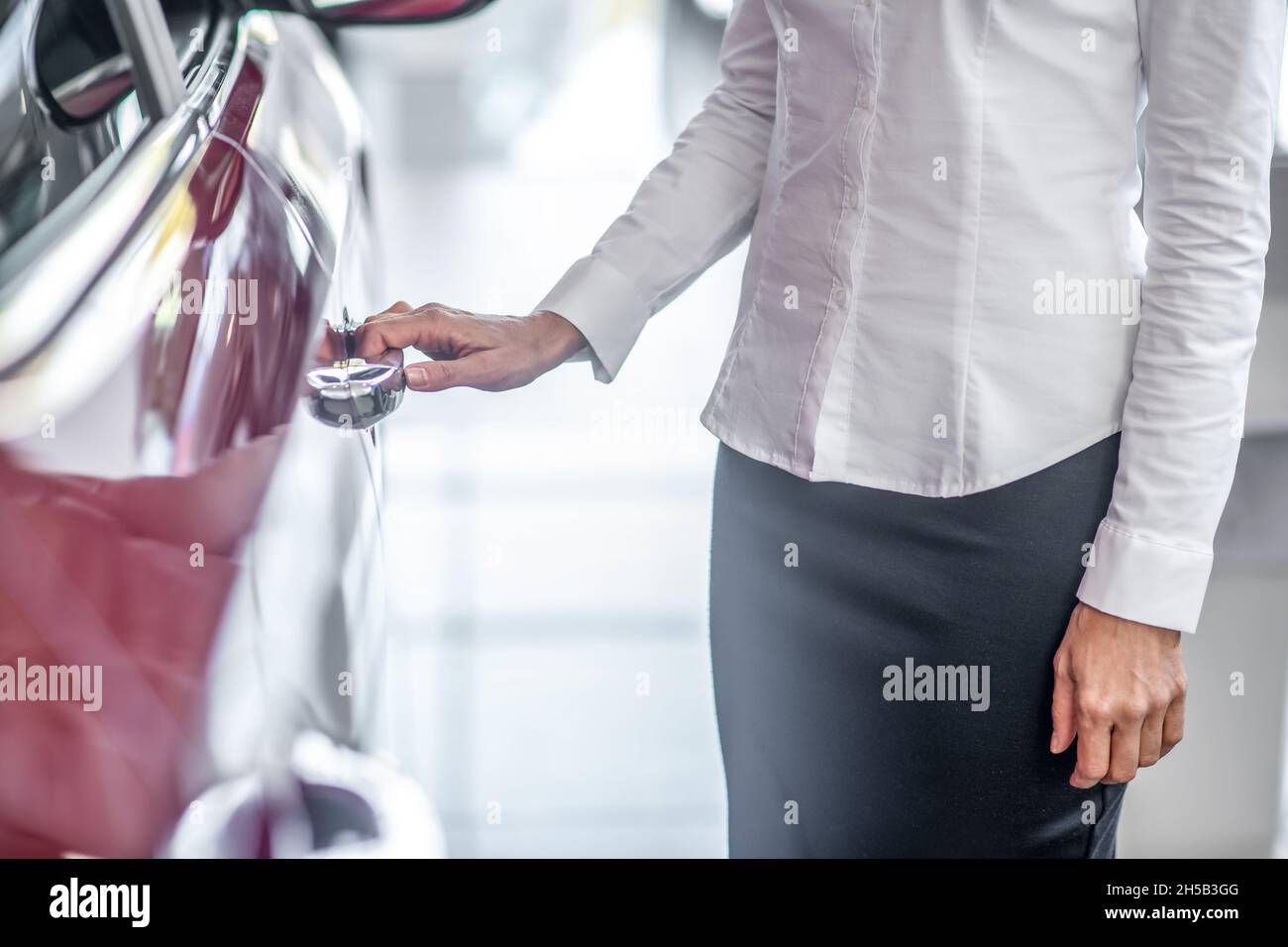 Womans hand touching door of new car Stock Photo Alamy