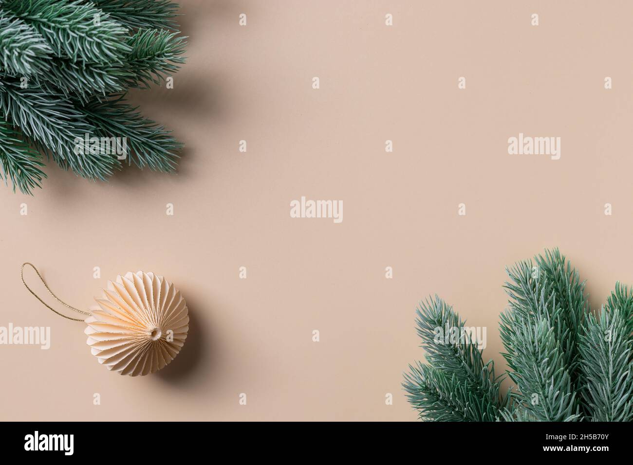 Christmas frame with paper decoration on beige background Stock Photo ...