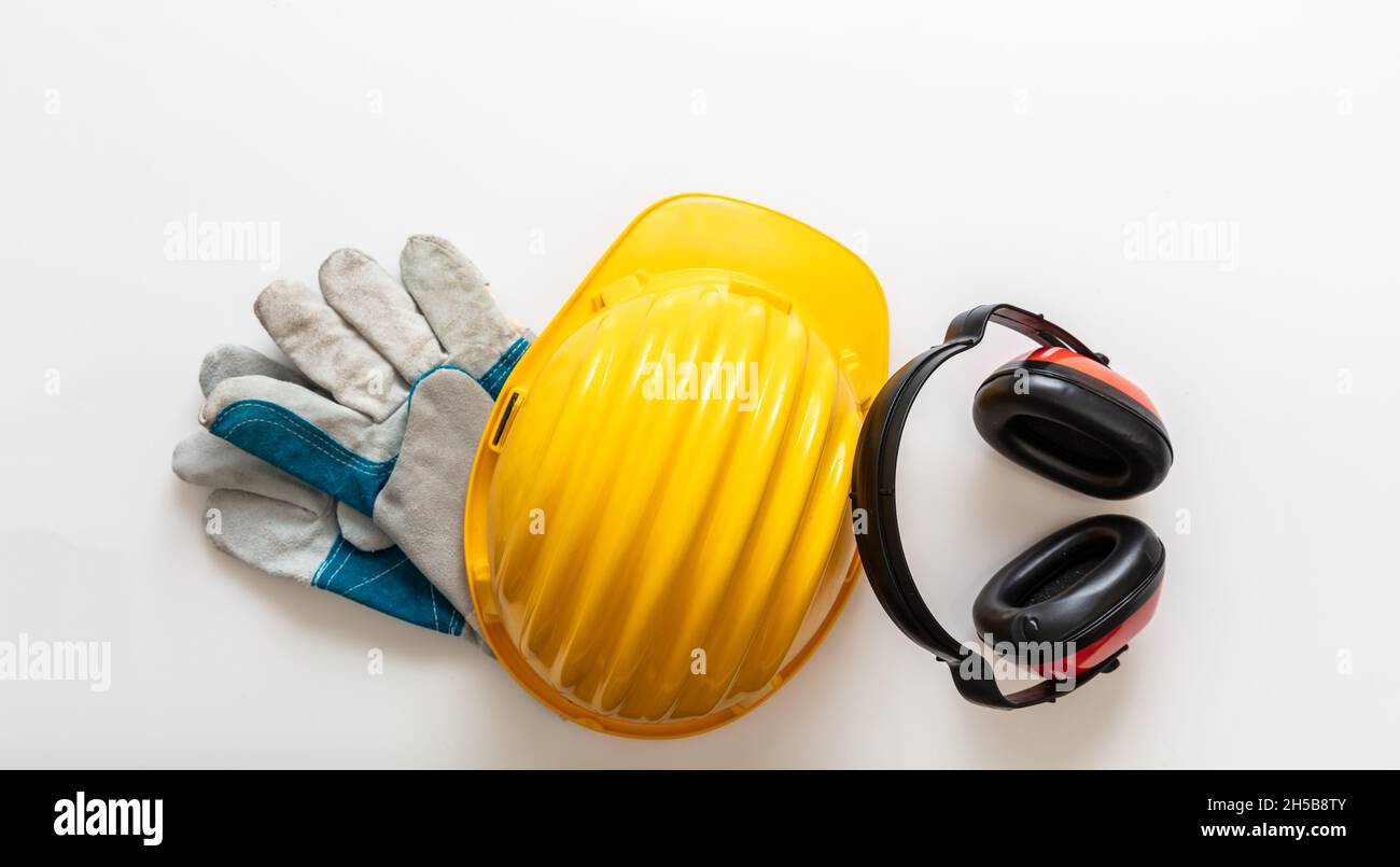 Safety equipment helmet gloves and ear muffs. Work wear protection isolated on white background, Personal protective gear, top view Stock Photo