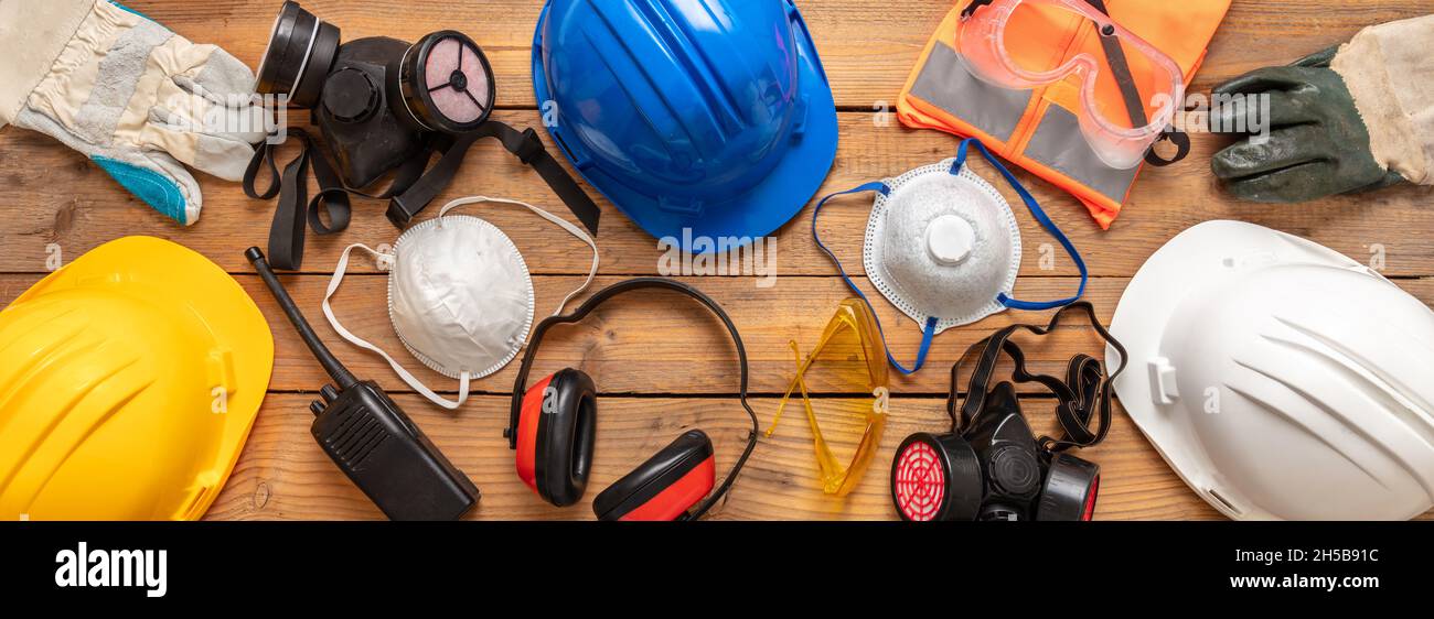 Work safety protection equipment. Industrial protective gear for two on  wooden background. Construction site health and safety concept Stock Photo  - Alamy