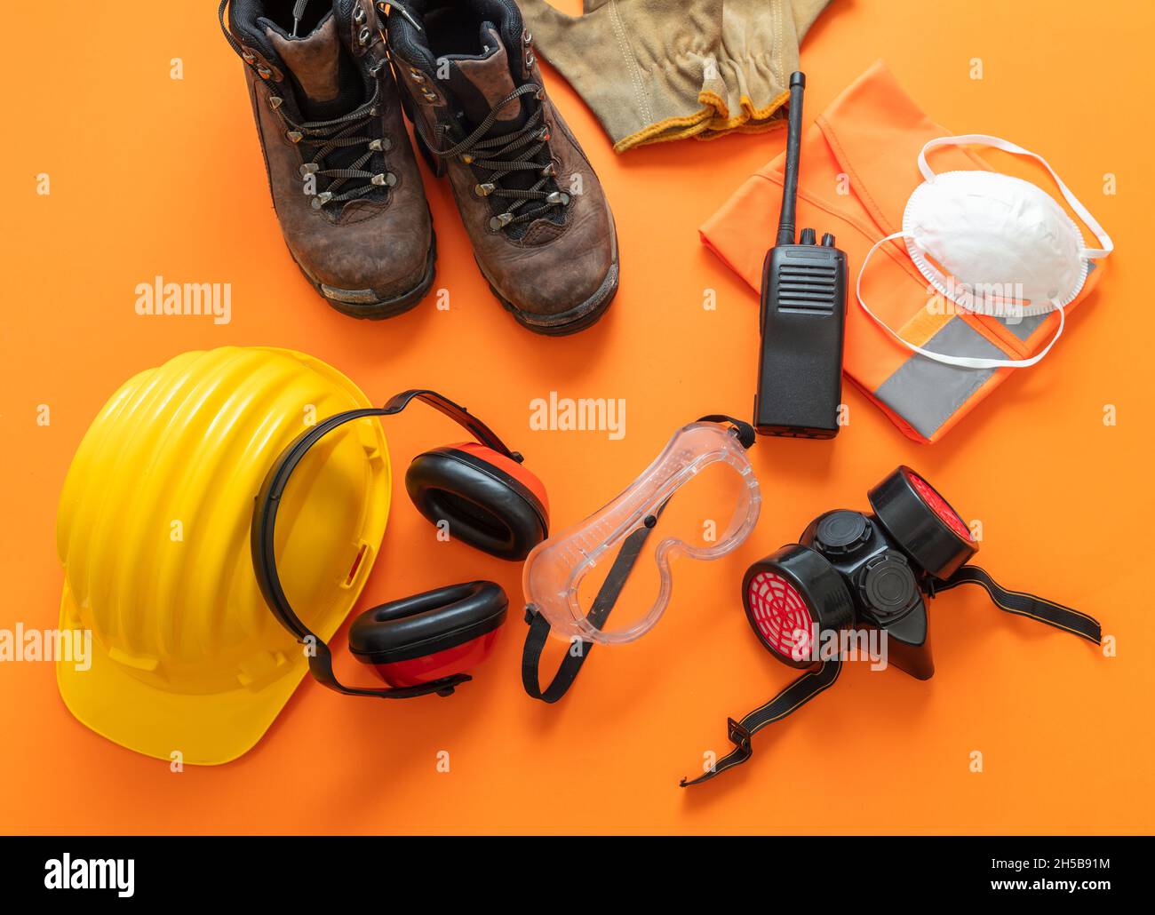 Safety protection work wear equipment on orange color background