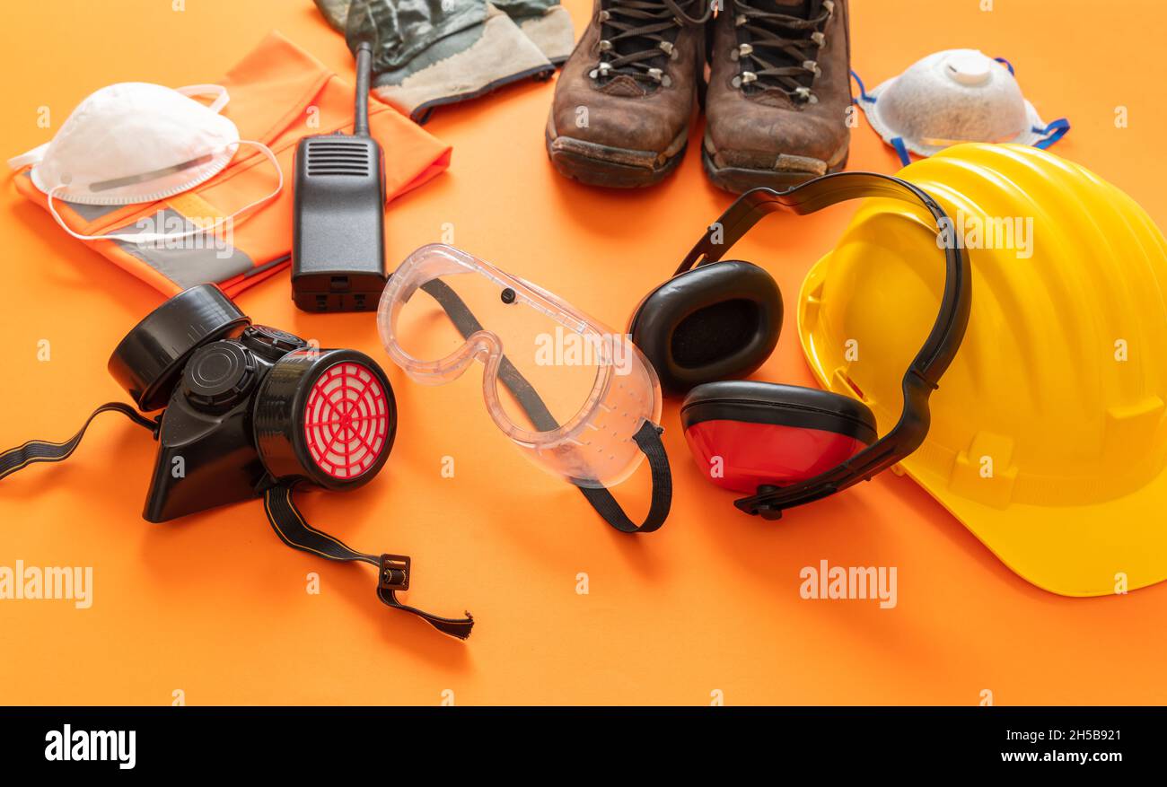 Work wear safety protection equipment on orange color background
