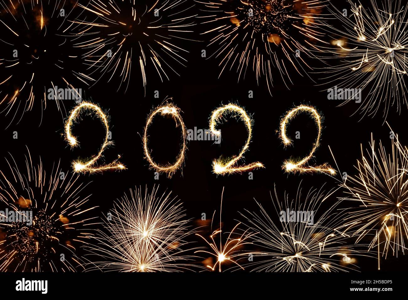 2022 written with sparkles and fireworks, new year greeting card Stock Photo