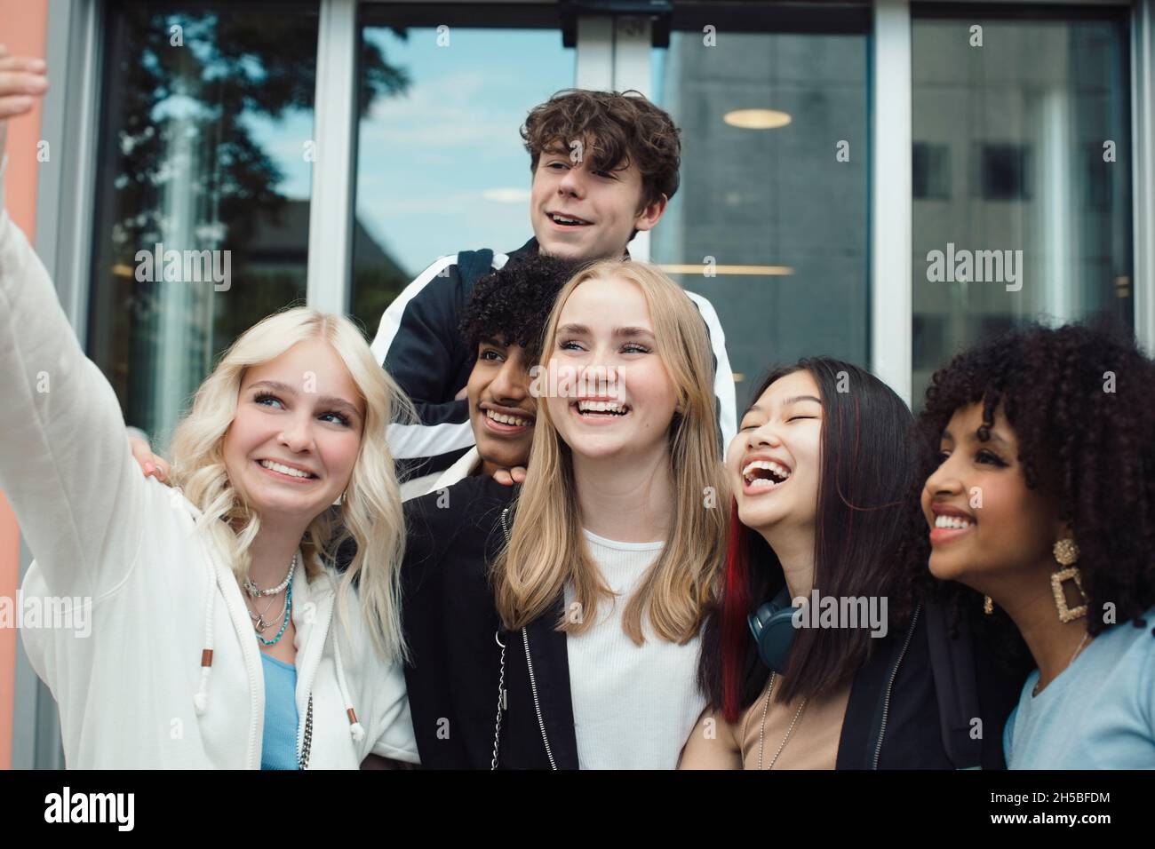 Smiling male and female friends taking selfie while hanging out Stock Photo