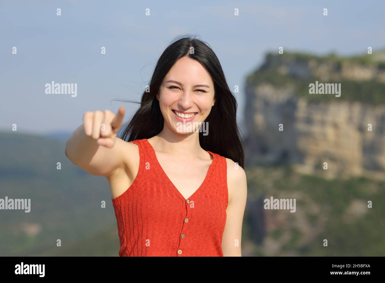 Front view portrait of an asian woman pointing at camera in the mountain Stock Photo