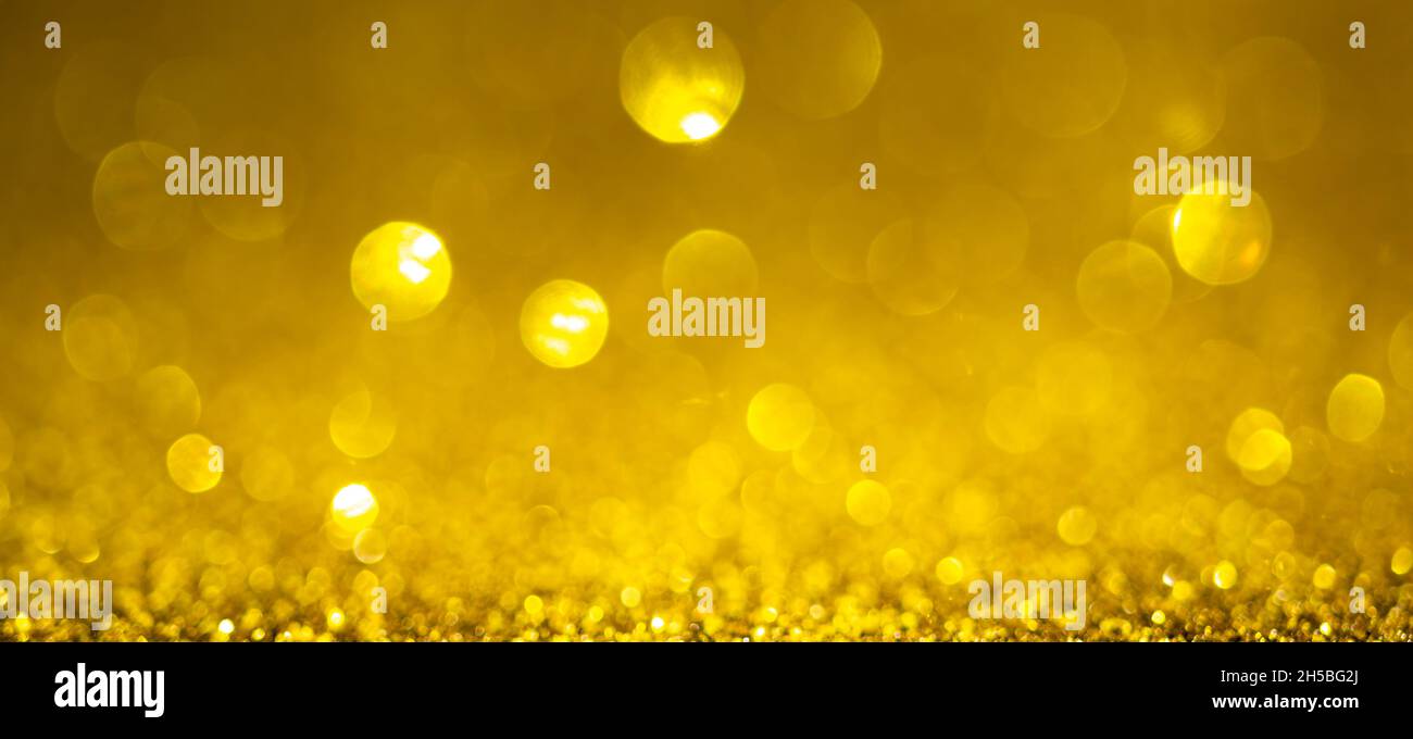 Gold Christmas lights background, banner design. Shiny glowing surface