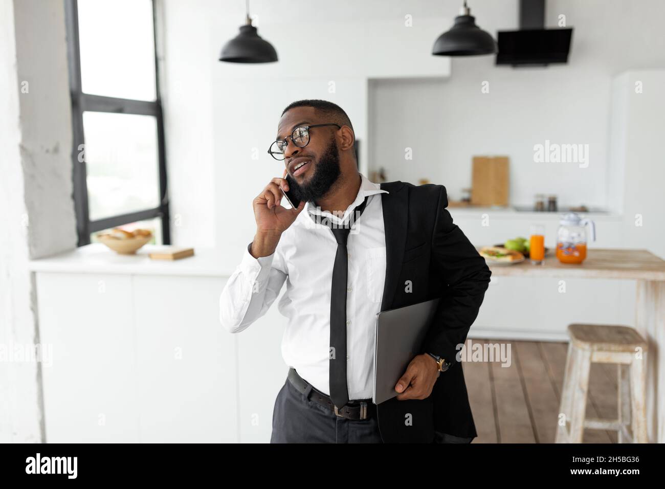 African American man talking on mobile phone in a hurry Stock Photo