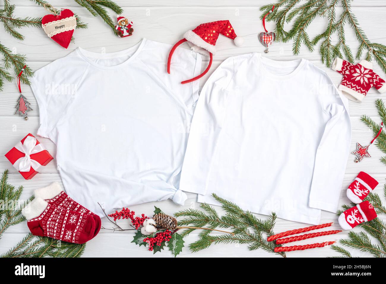 Children clothes with Christmas symbols and decor on table Stock Photo