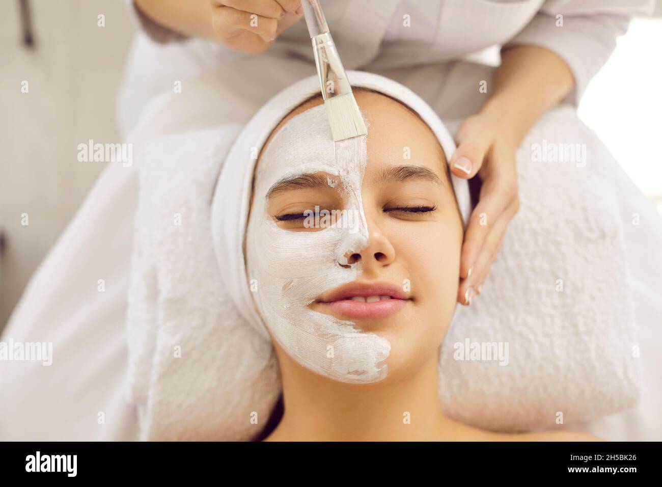 Young woman getting professional cosmetic facial treatment in spa or beauty salon Stock Photo