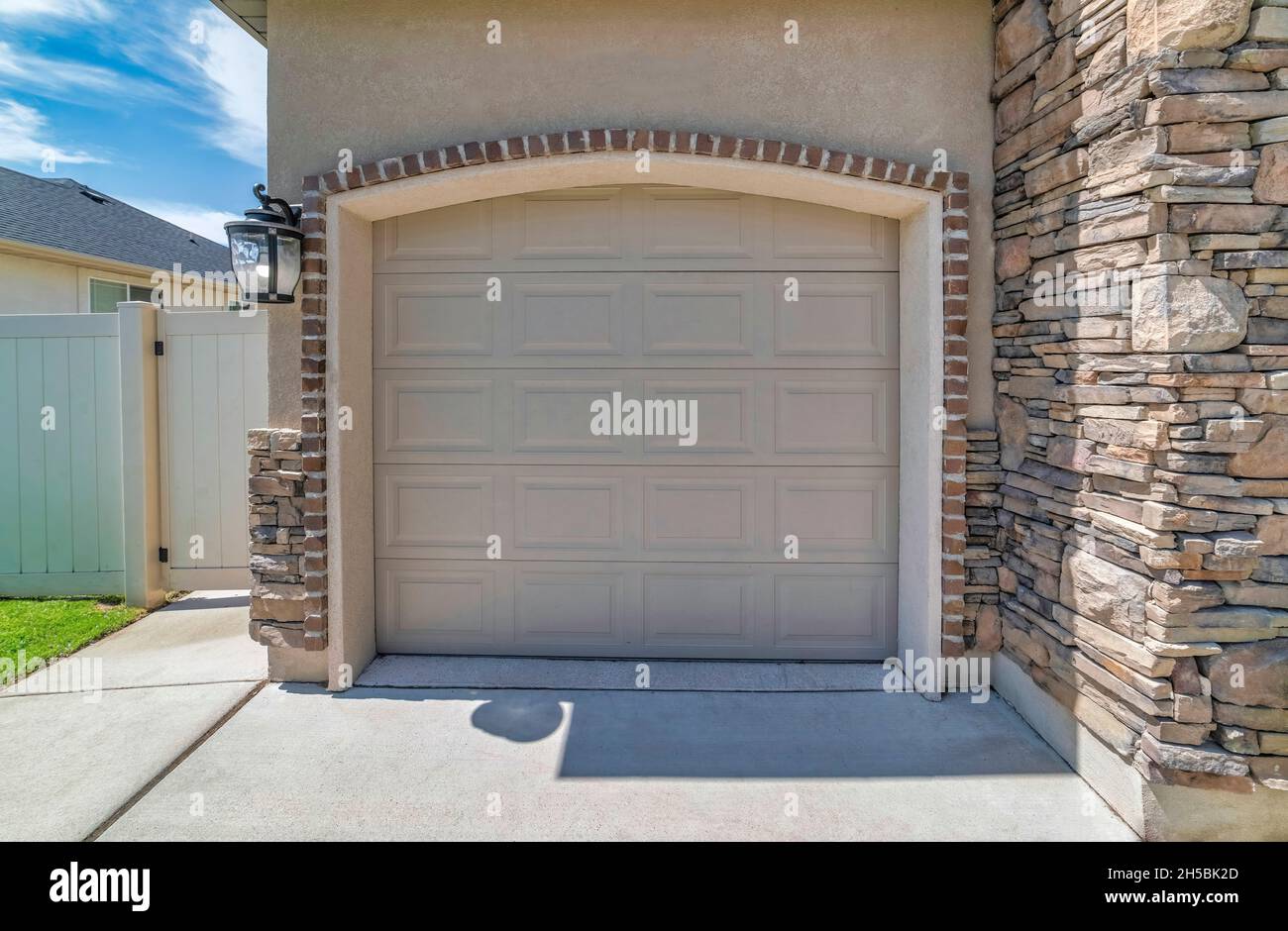 Beige sectional garage door with arched door opening Stock Photo Alamy