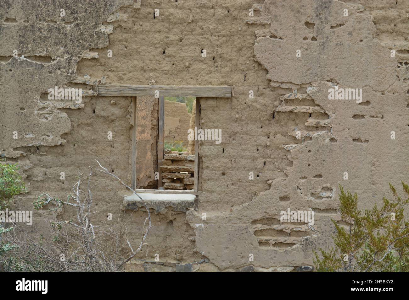 The wood windows on the adobe walls. Perspective. Stock Photo