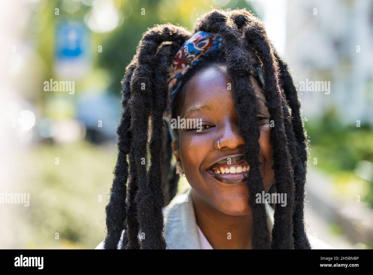 Portrait of smiling young woman outdoors Stock Photo - Alamy