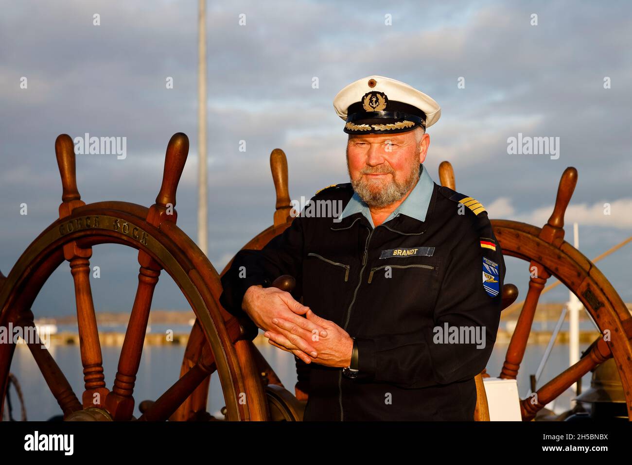 Kiel, Germany. 08th Nov, 2021. The commander of the sail training ship 'Gorch Fock', Captain Nils Brandt, stands on the deck. On the fringes of a press event, it became known that the first training voyage of the retreaded sail training ship will be postponed at short notice. A navy spokesman said the reason was germs in the drinking water system. Credit: Frank Molter/dpa/Alamy Live News Stock Photo