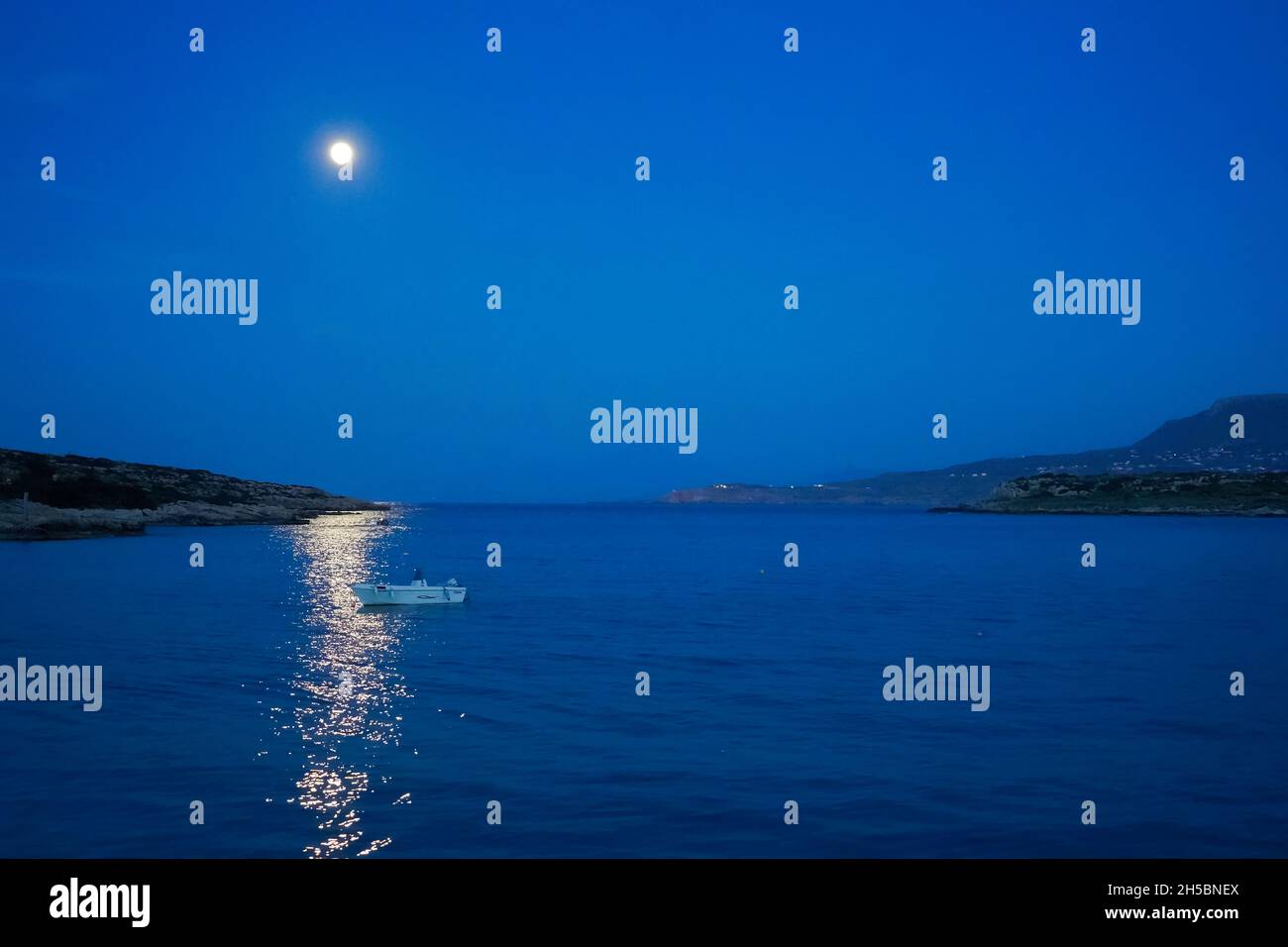 Moonlight over the ancient harbour of Chania, Crete. Greece Stock Photo