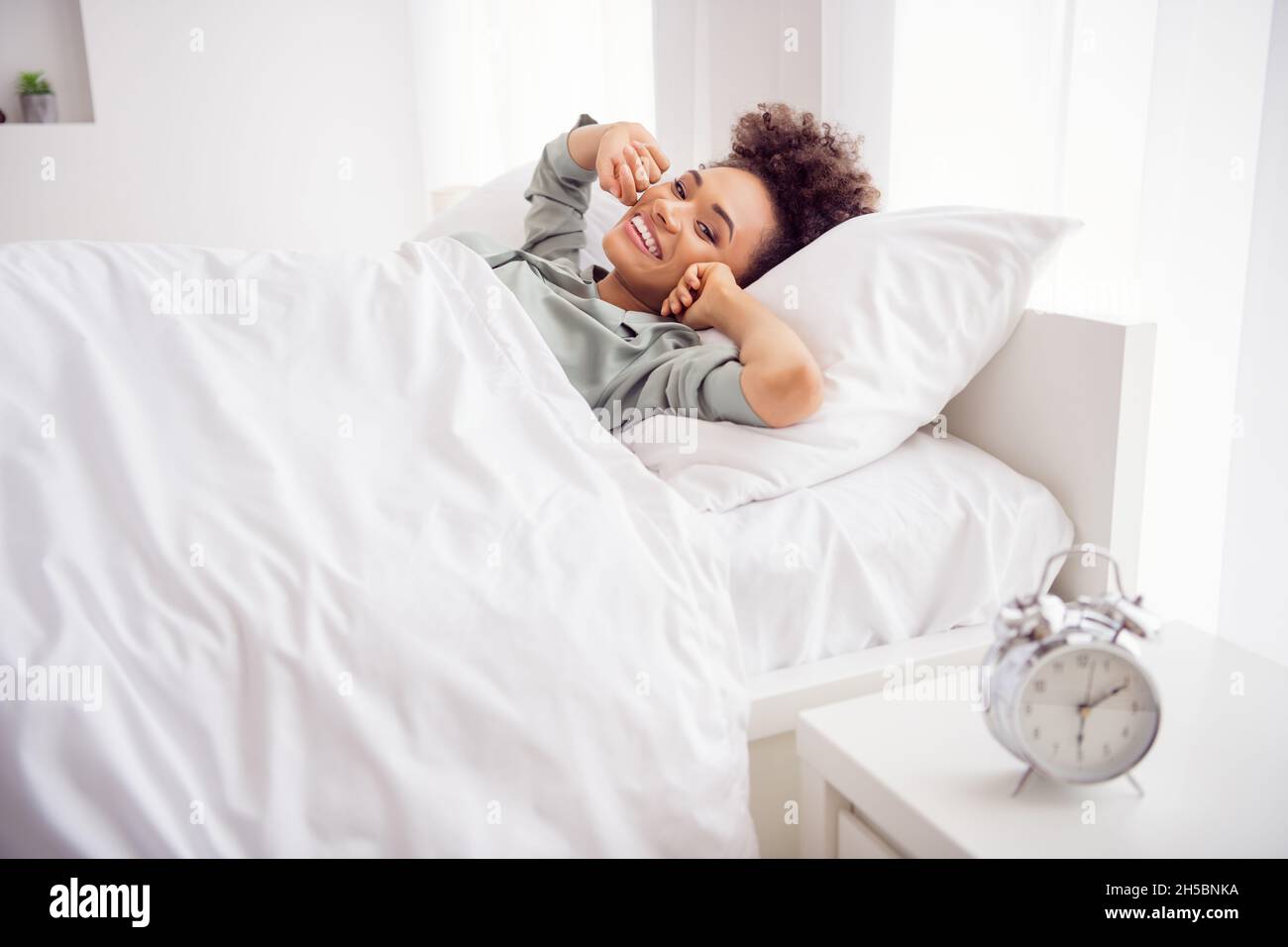Portrait Of Attractive Cheerful Wavy Haired Girl Lying In Bed Waking Up