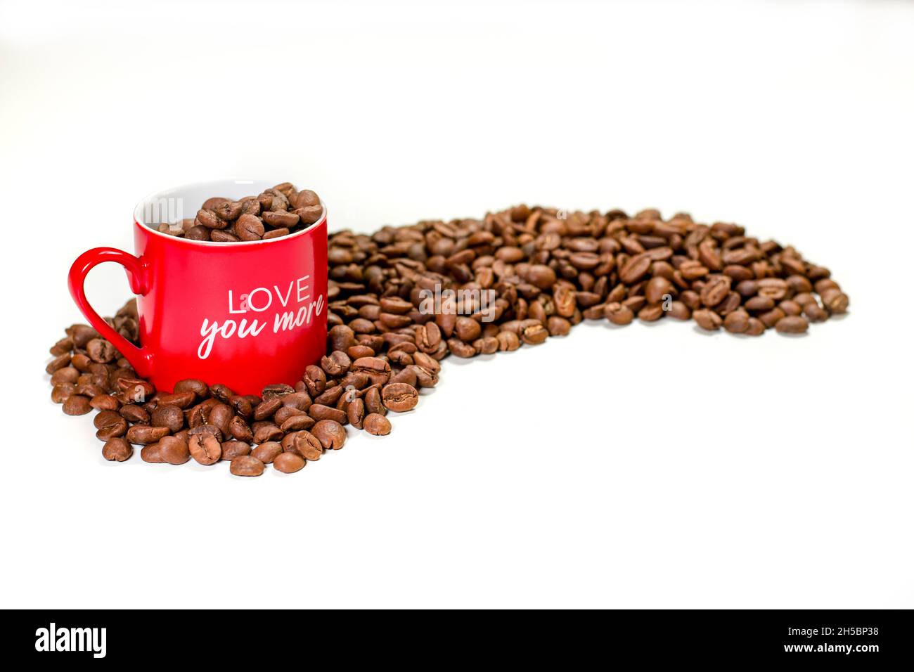coffee grains in cup and table top on white table Stock Photo