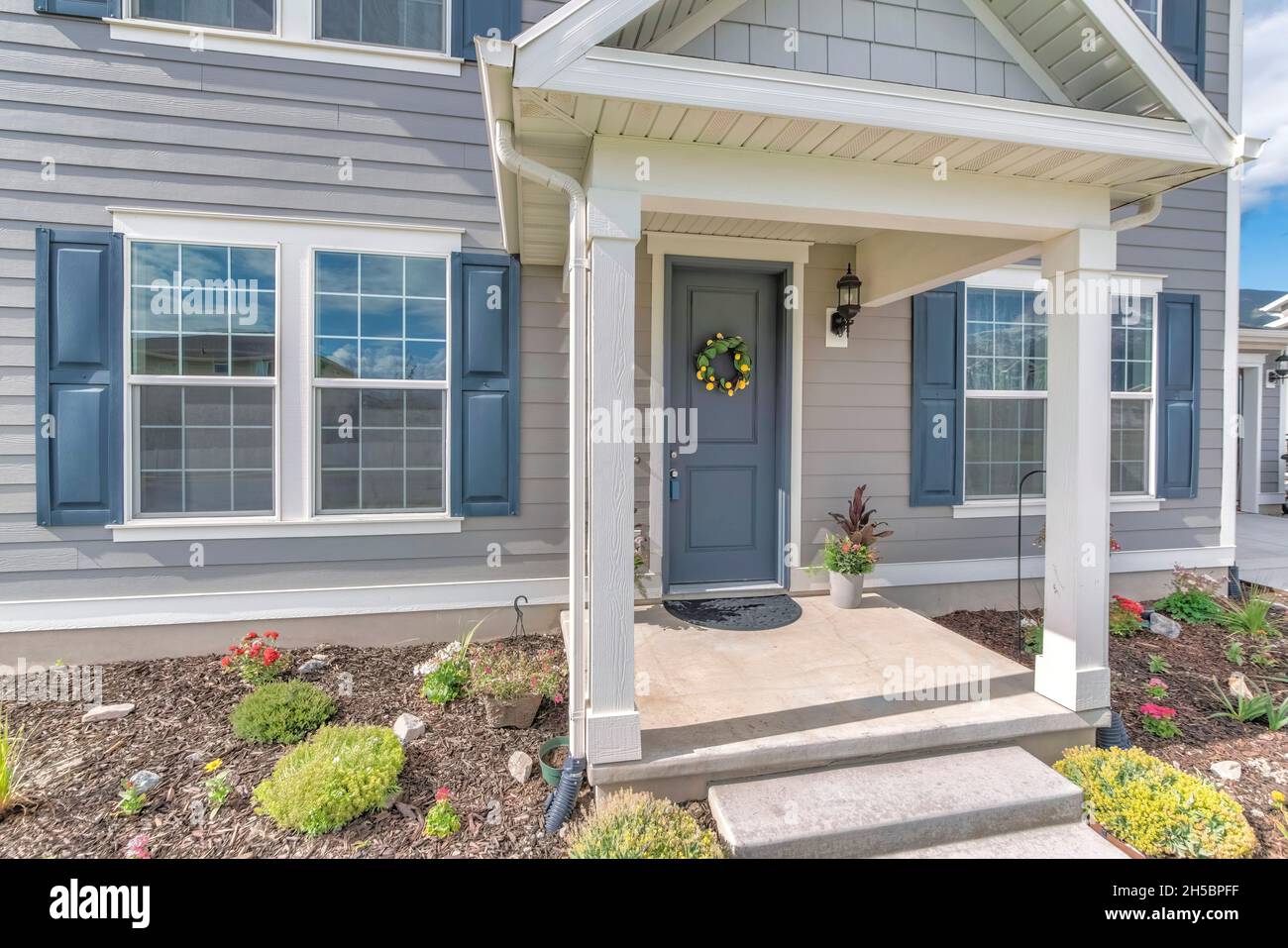 Picture of Home exterior with gray wood vinyl siding and white frames Stock Photo ...