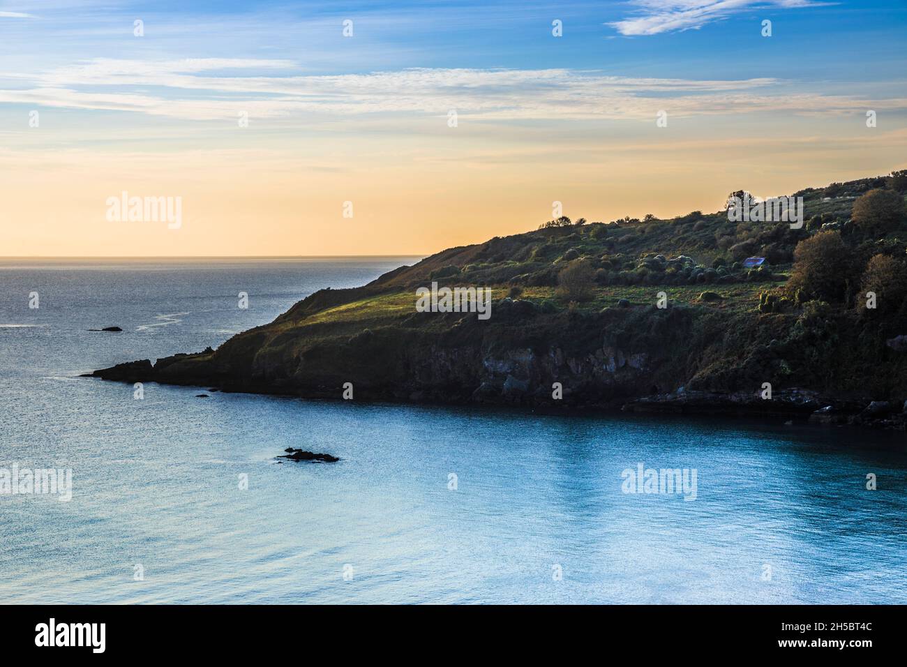 Early morning light falls on St.Mary's Bay in south Devon. Stock Photo