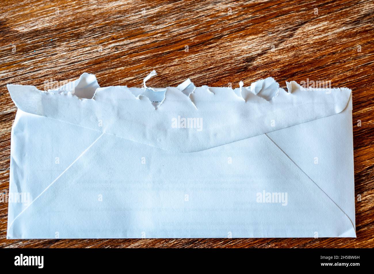 Selective focus on jagged edges of a ripped open mail envelope Stock Photo Alamy