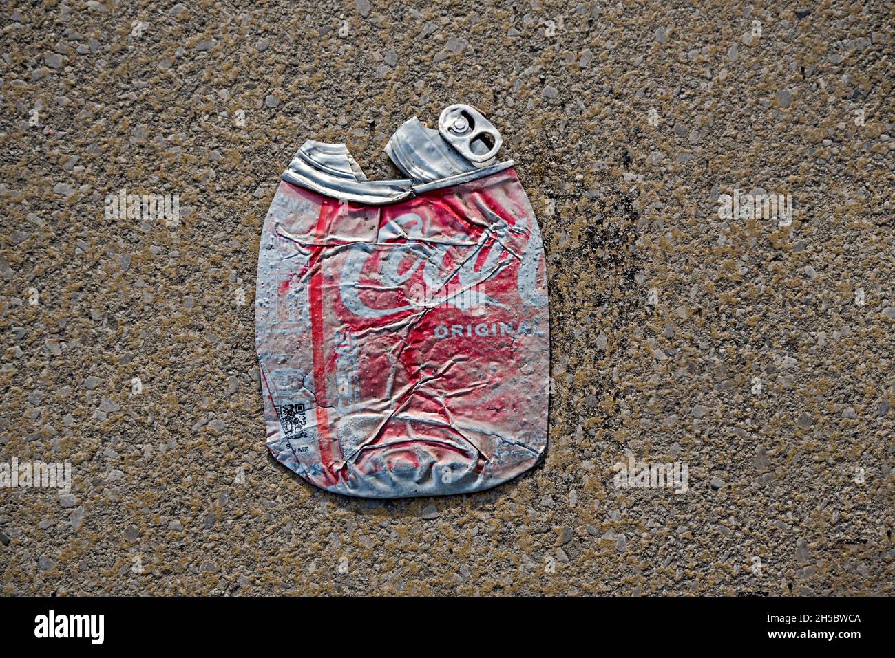 Crushed and faded coca-cola can. Stock Photo