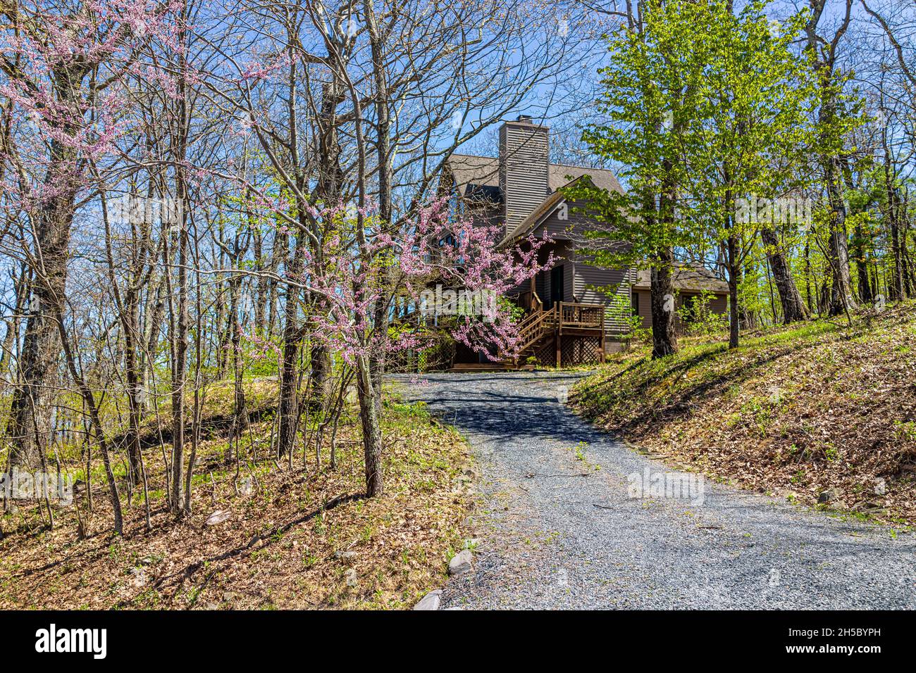 Single family mountain vacation rental house with gravel road driveway