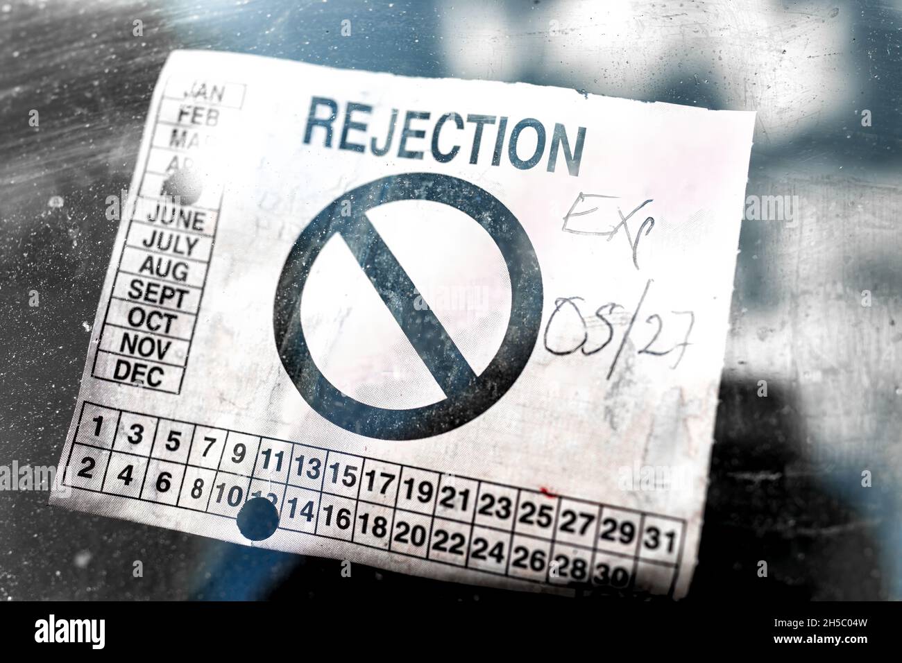 Rejection notice sticker for failing failure of safety state inspection attached to front car vehicle auto windshield window in United States Stock Photo