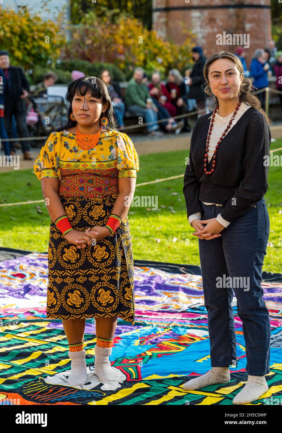 Agar Iklenia Tejeda interviewed with interpreter about applique Mola sail handsewn by indigenous Guna women from Panama at COP26, Glasgow, Scotland Stock Photo