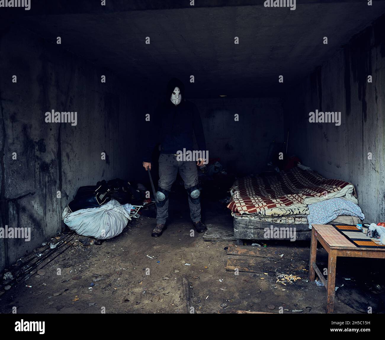 Serial killer Jason Voorhees in hockey mask in his maniac lair. Friday 13th cosplay costume