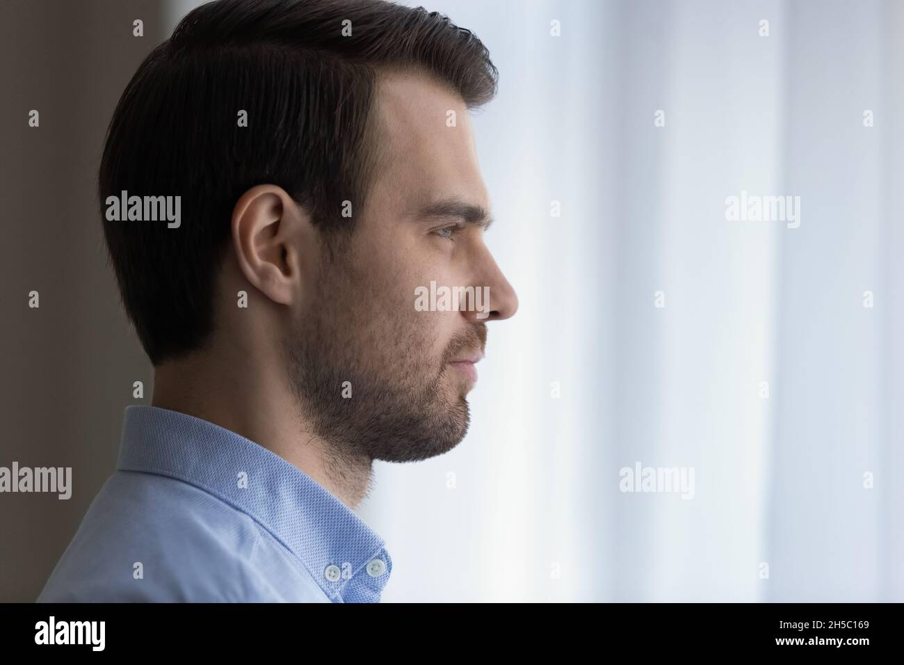 Dreamy confident young man looking in distance. Stock Photo