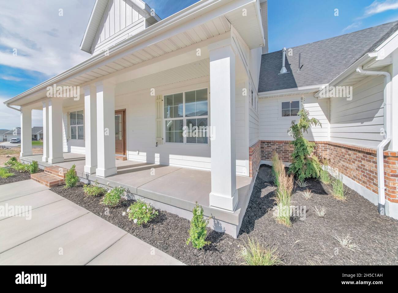 Exterior of a house with white vinyl wood and bricks siding Stock Photo ...