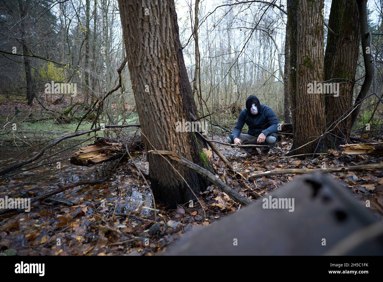 Serial killer Jason Voorhees in hockey mask at the swamp in the autumn