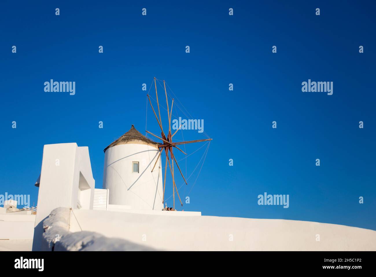 View at traditional windmill in Oia on Santorini island, Greece Stock Photo