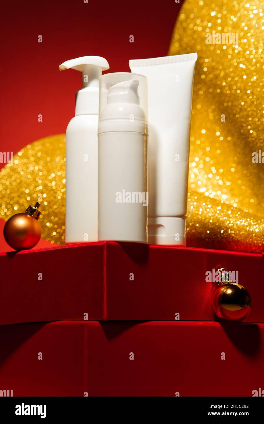 Majestic red podium from gift boxes with cosmetics mockups, gold ...