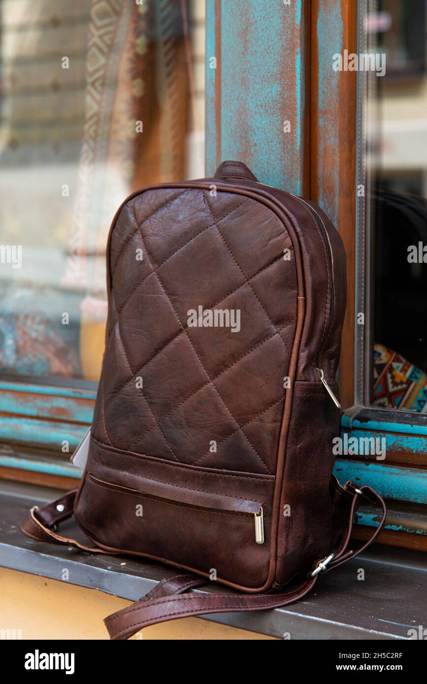 Brown leather backpack on the windowsill Stock Photo