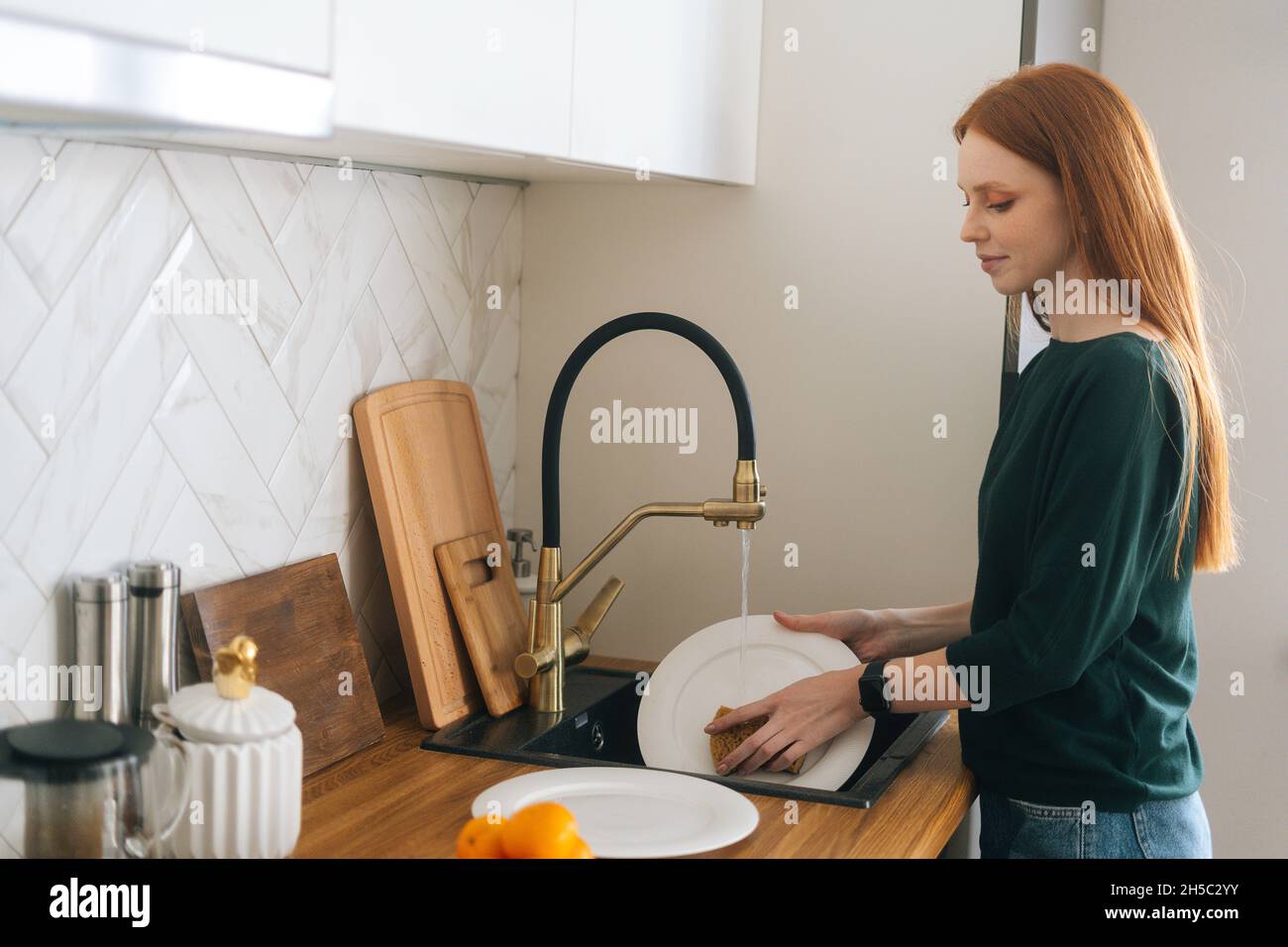 Attractive Young Woman Is Washing Dishes While Doing Cleaning At Home Stock  Photo, Picture and Royalty Free Image. Image 91906745.