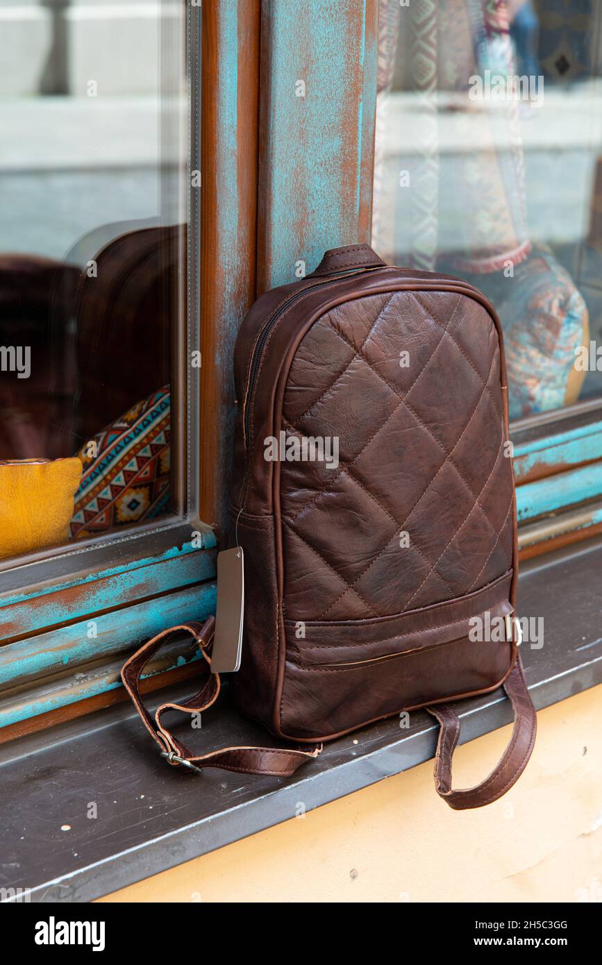 Brown leather backpack on the windowsill Stock Photo