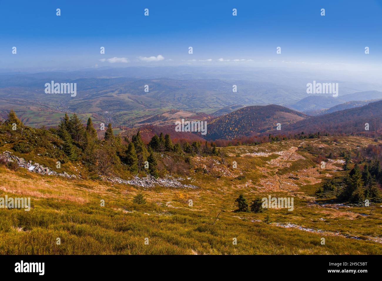 View of hills of Water Dividing ridge covered in red, orange and yellow ...