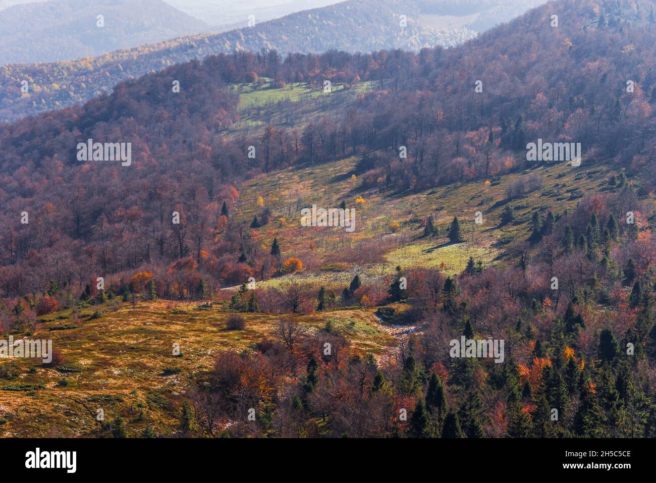 View of hills of Water Dividing ridge covered in red, orange and yellow ...