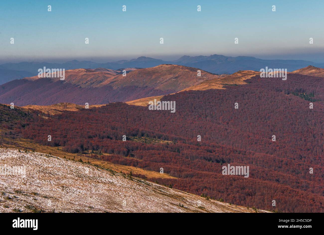 View of hills of Water Dividing ridge covered in red, orange and yellow ...
