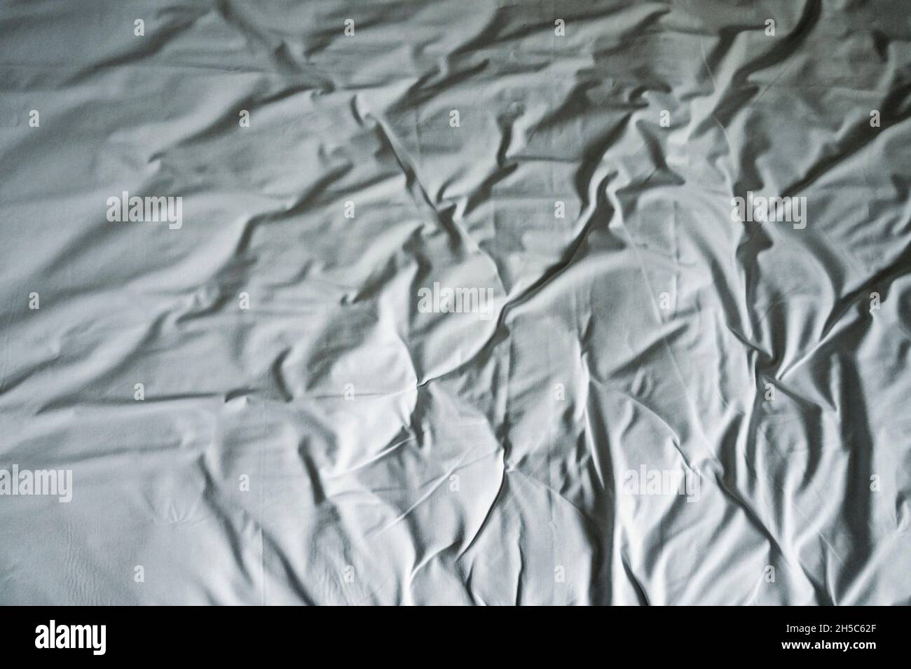 Crumpled bed linen in hotel Stock Photo