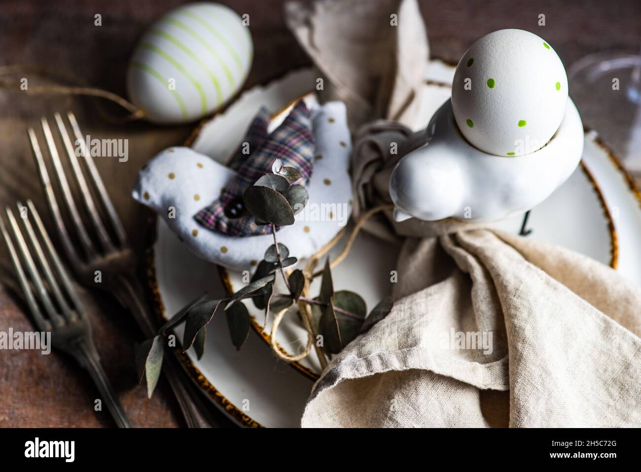 Rustic table setting with Easter eggs for Easter dinner Stock Photo - Alamy