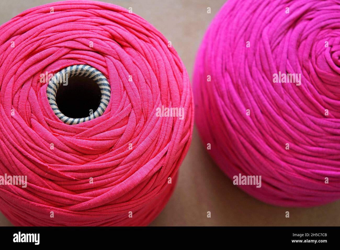 Pink balls of wool on table Stock Photo