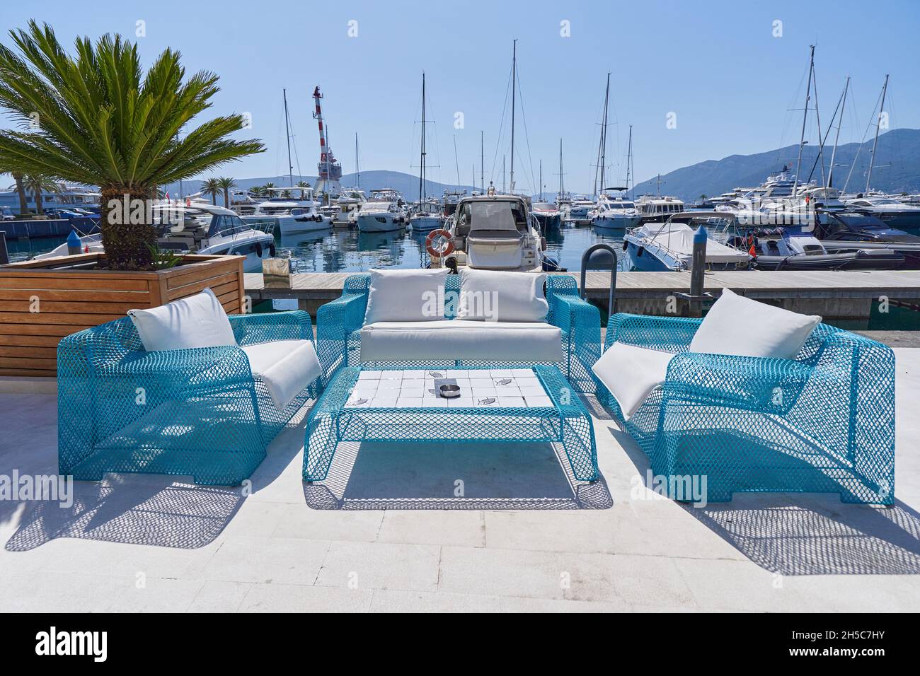 Outdoor furniture from mesh in a street cafe by the sea in Europe. Stock Photo