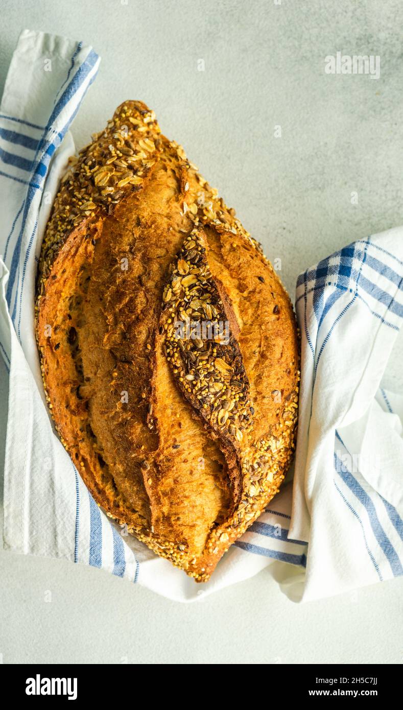 Overhead view of a loaf of sourdough bread with nuts and seeds wrapped