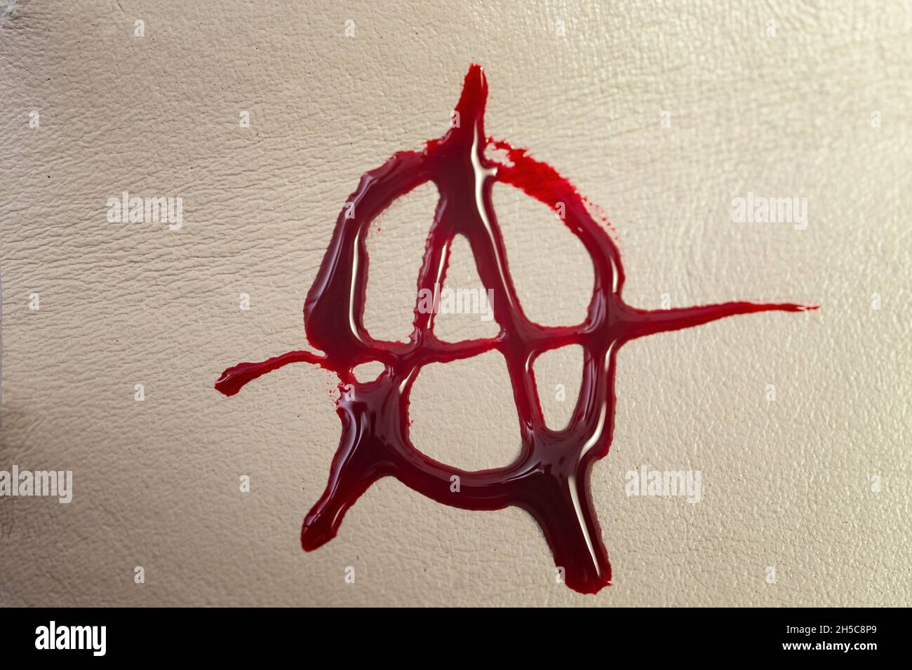 anarchy symbol made with blood on fake leather texture Stock Photo