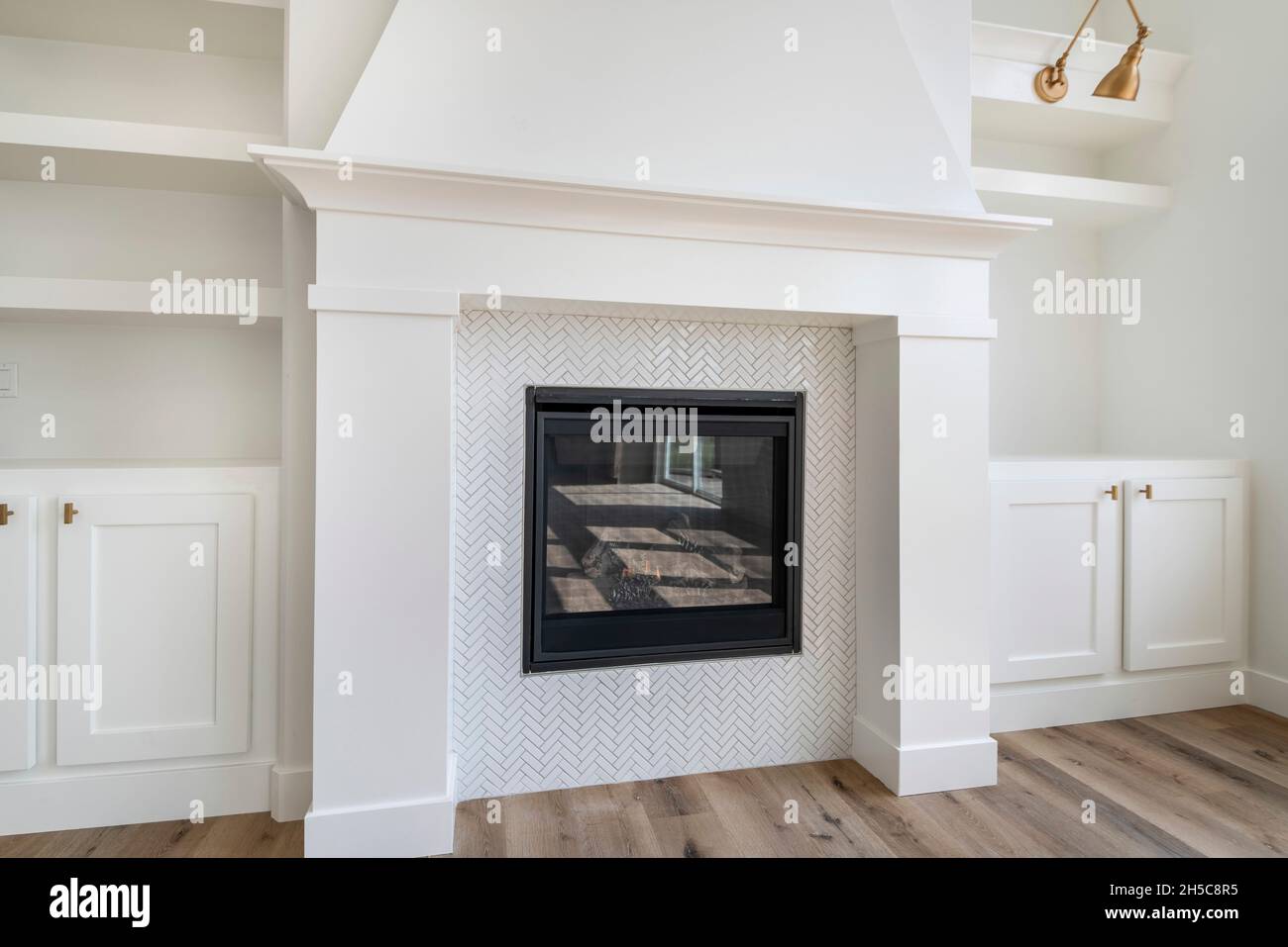 Fireplace with white tiles in herringbone pattern surround Stock Photo